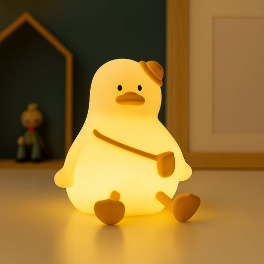 veilleuse canard silicone bébé sur canapé