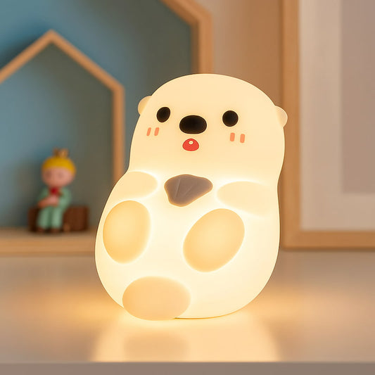 veilleuse loutre silicone allumée sur lit